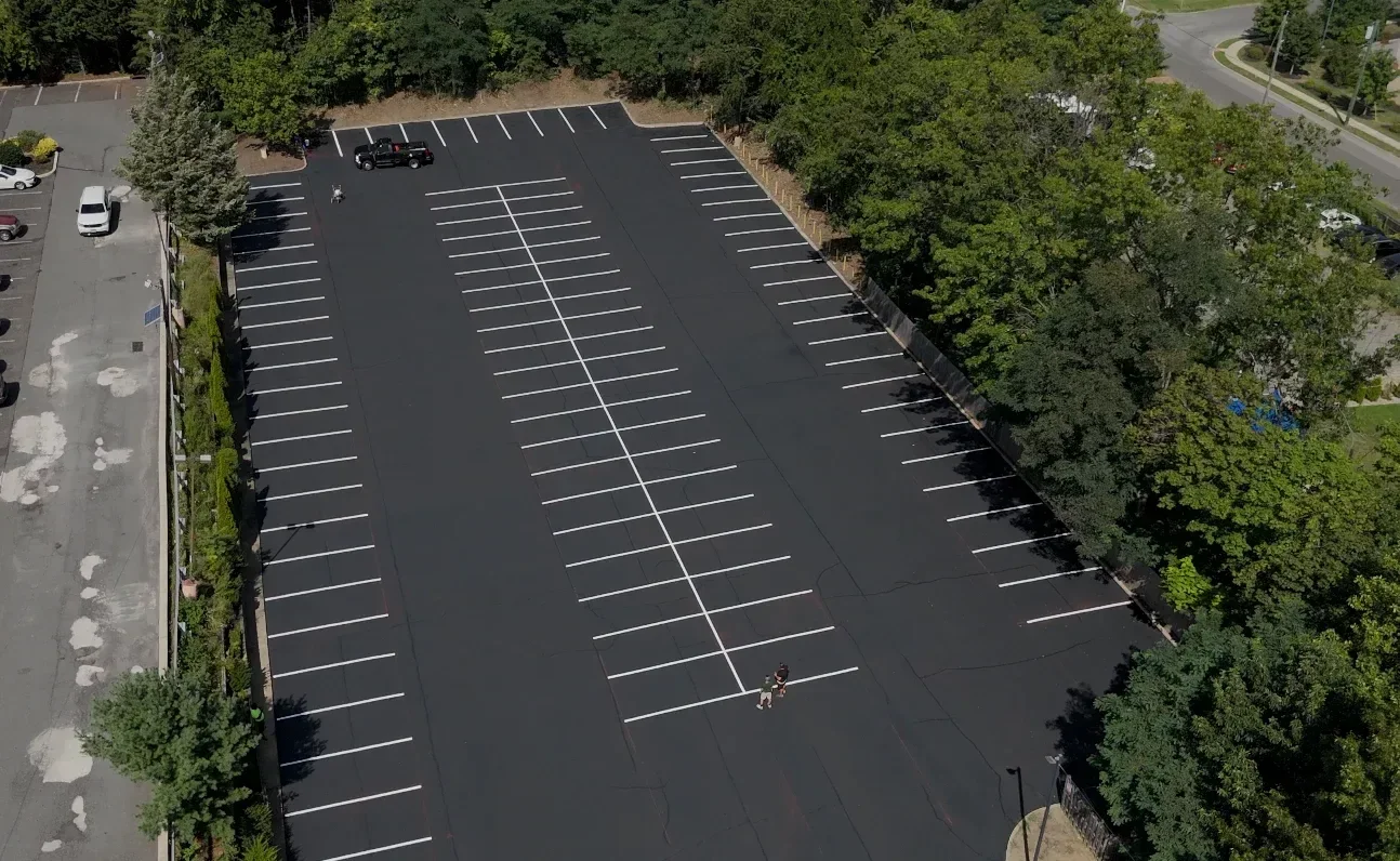 Editorial aerial view of a commercial parking area with fresh line striping.