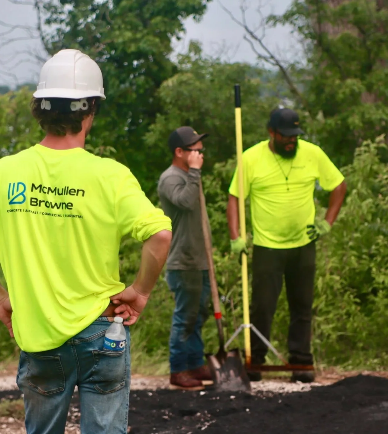 McMullen Browne crew members working on a pavement project at an outdoor site.