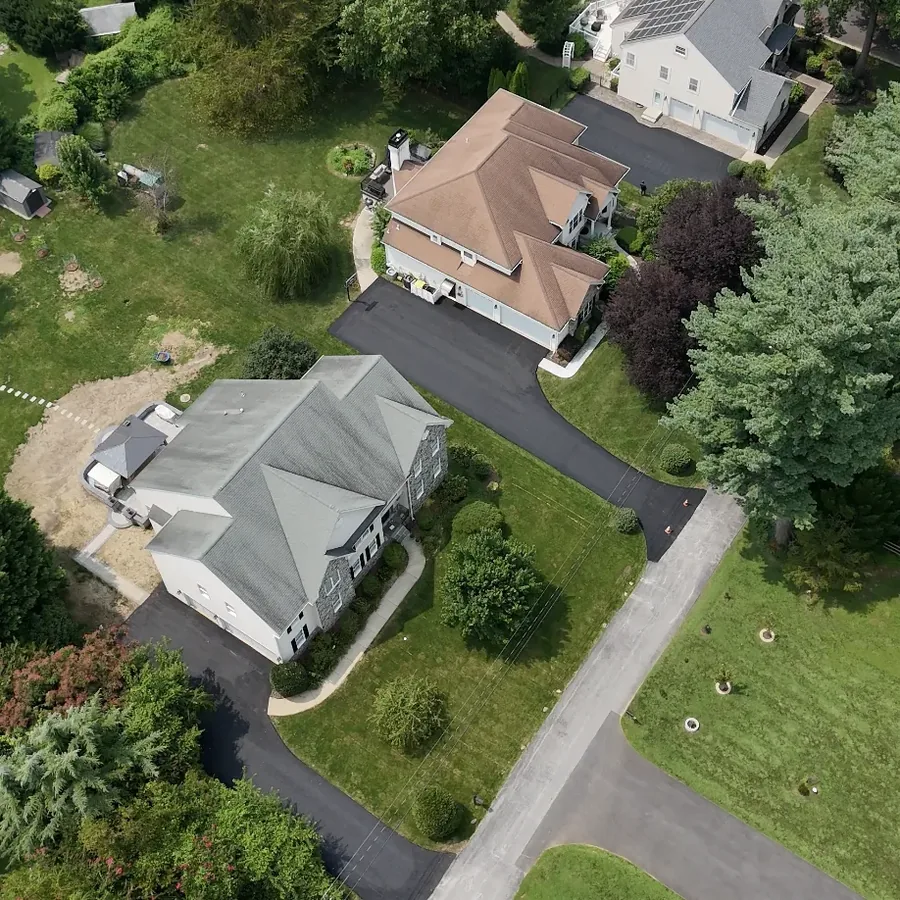 Aerial view of completed residential roofing in a neighborhood